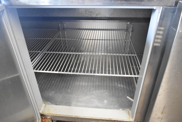 2018 Continental CPA93 stainless steel pizza prep table, commercial casters, 115 Volts, open shelving.