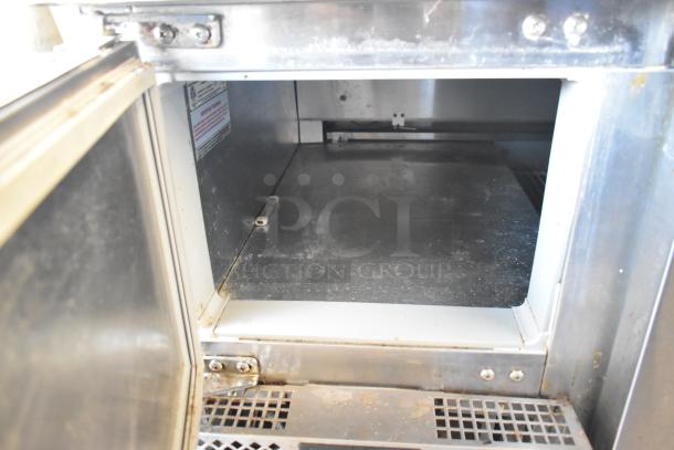 2018 Continental CPA93 stainless steel commercial pizza prep table interior, showing open compartment with slight wear.