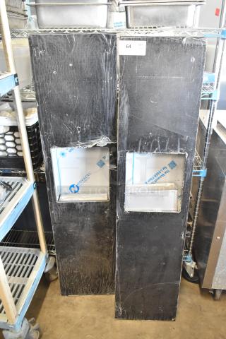Two black metal storage units with visible wear; rectangular opening on each. Labels read "Novacel" and "64 QTY," indicating lot info.