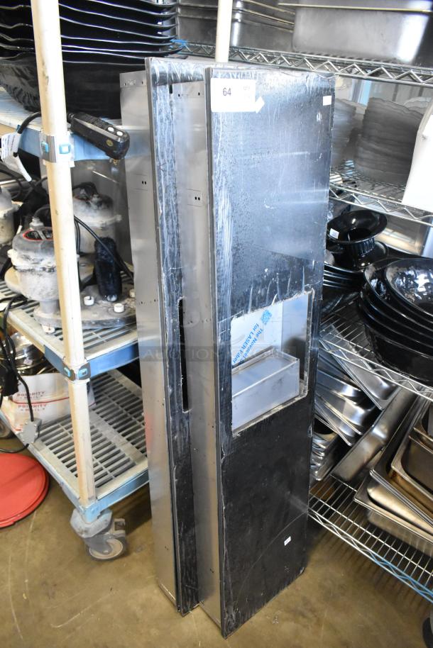 Two metal units, standing vertically. Features include a visible storage compartment. Condition appears used and sturdy. Item labeled "64 QTY".