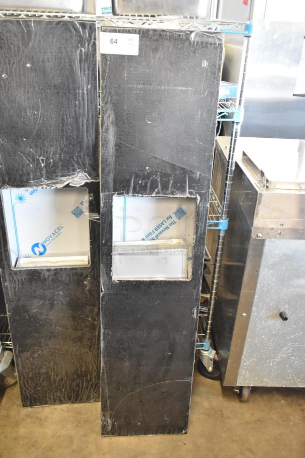 Two black metal units with rectangular cutouts, slightly scratched surfaces, labeled "64." Auction item doubles bid value.