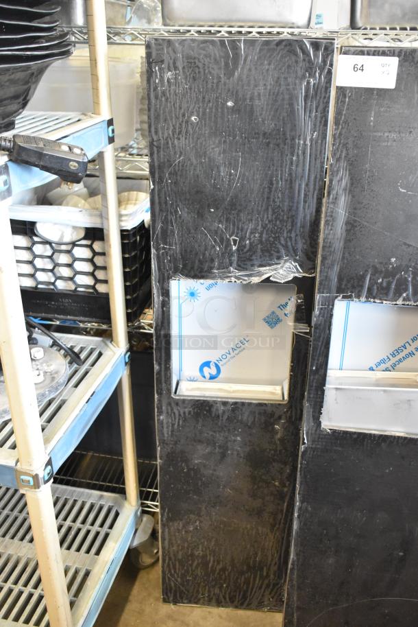 Two black metal panels, each featuring a square cutout with Novacel protective film. Item labeled as quantity 64.