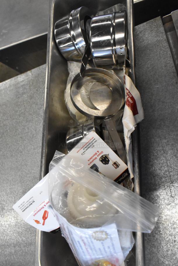 Two-tier lot includes black bowls, ChefMaster single burner butane range, and various kitchen items in steel container.