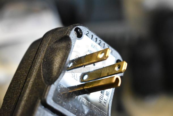 Close-up of a power plug with visible prongs, suggesting the Bar Maid Electric Glass Washer's voltage and phase requirements.