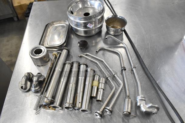 Lot of various metal items including server pump parts. Items show signs of wear. Auction tag visible on bowl.