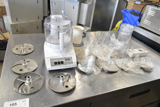 Waring food processor with 2 S blades, 6 slicing blades, 1 grating blade, 120 volts, 1 phase, good condition.