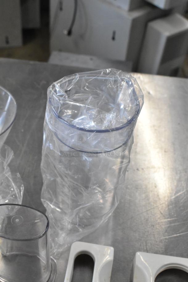 Waring food processor accessories in plastic wrap, including two S blades, six slicing blades, and one grating blade.