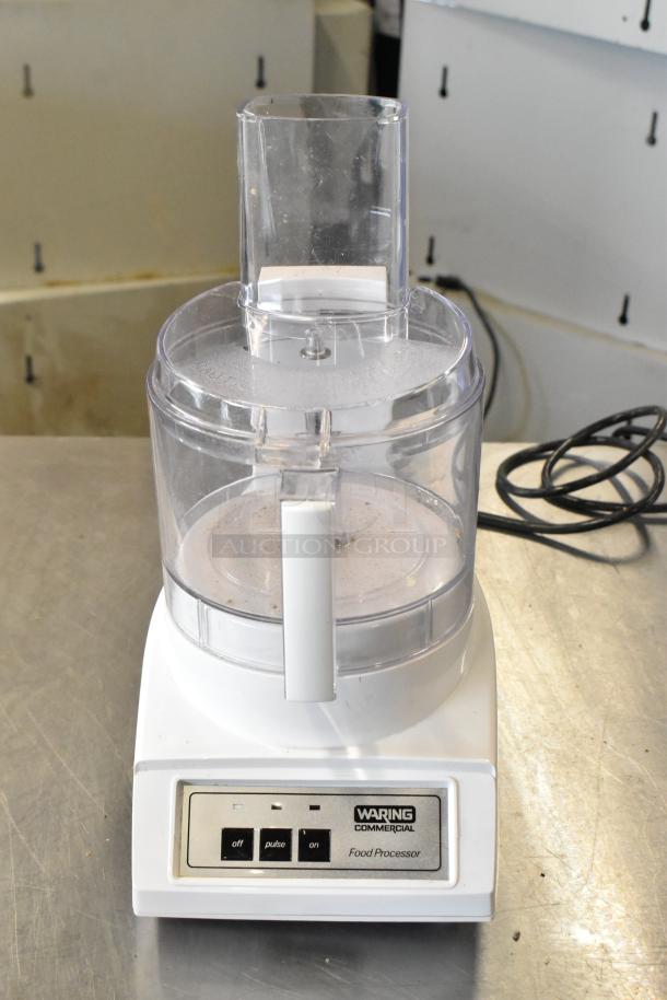 Waring Commercial food processor with 2 S blades, 6 slicing blades, 1 grating blade, 120 volts, 1 phase, visible control panel.