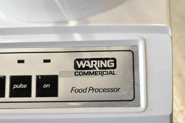 Waring Commercial food processor with controls, in good condition. Includes 2 S blades, 6 slicing blades, and 1 grating blade.