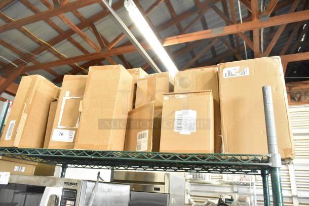 Auction lot with various items, including stackable storage drawers and Sabatier potato ricer blade. Boxes on shelf, labels visible.