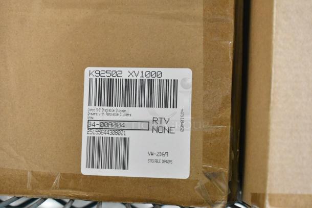 Cardboard box with a label showing "Copco S/2 Stackable Storage Drawers with Removable Dividers, Gray". Item code B4-00A004.