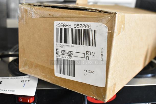 Cardboard box labeled "Sabatier Interchangeable Blade Potato Ricer." Contains various items including stackable storage drawers.