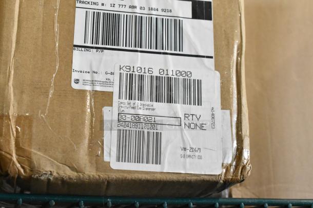 Cardboard box with shipping labels, marked for stackable gravity-feed egg dispenser, part of a tier lot auction.