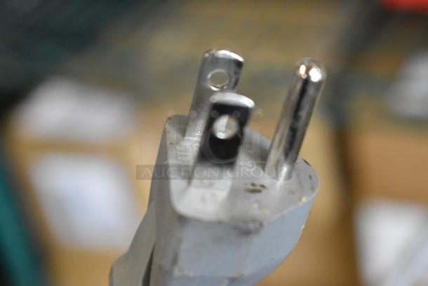 Close-up of plug for Solwave 180MW1000SS commercial microwave, showing three-prong design for 120V power connection.
