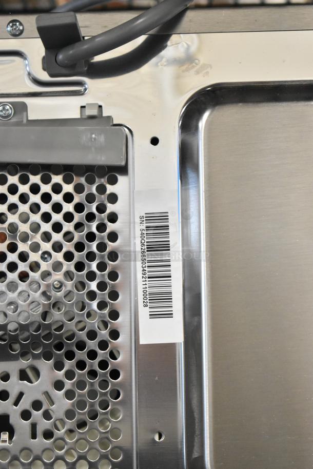 2024 Solwave 180MW1000SS stainless steel commercial countertop microwave oven. Barcode label visible. Condition appears unused.