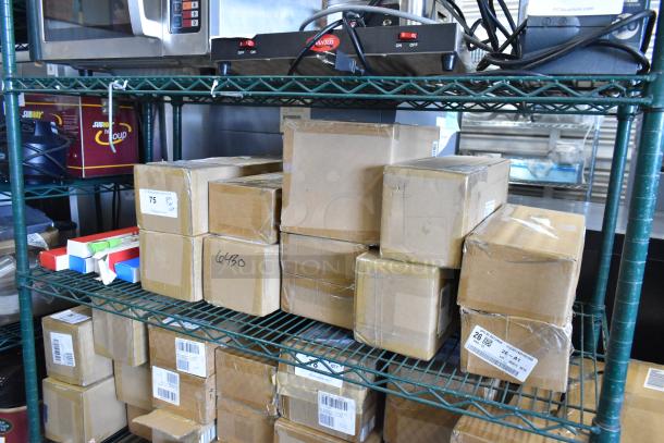 Tiered lot of various boxed items on shelving, includes Sabatier potato ricer blade and stackable egg dispensers. Labels present.