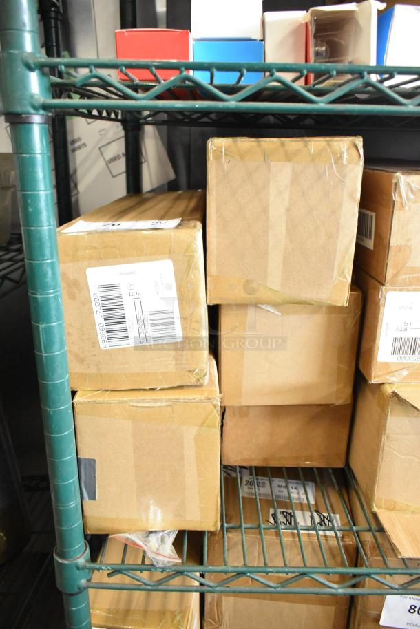 5 boxes of new Copco Rinse and Store Multi Function Storage Bin in gray, red, aqua; on a shelf, sealed, with labels.