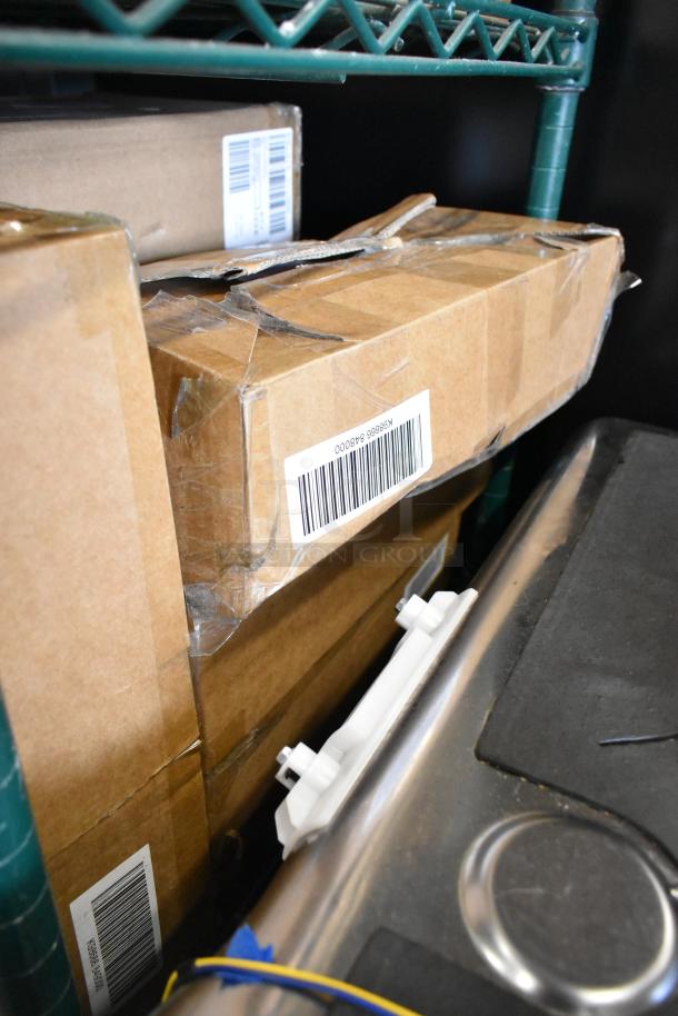Four boxes of brand-new items, including an interchangeable blade for a potato ricer, barcode visible on boxes.