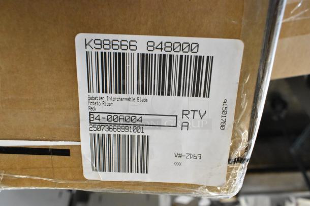Box with Sabatier interchangeable blade potato ricer, red. Barcode and product label visible. Brand new condition.
