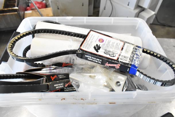 Container with assorted items including Browning drive belts, rollers, and plastic components. Items are in varied condition.