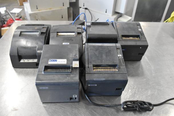Six Epson receipt printers, varied models, used condition. Visible DBS label on one unit. Sold as a lot.