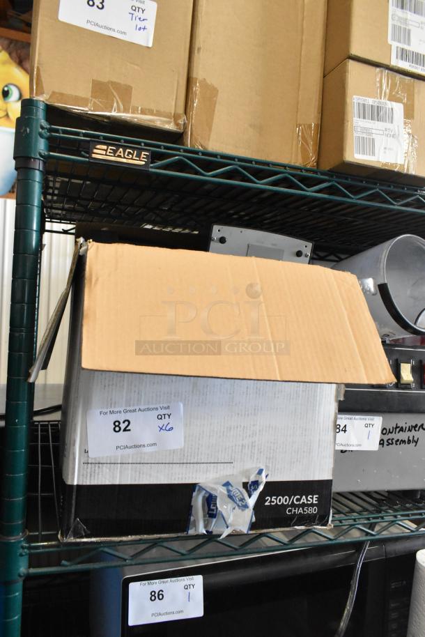 Box containing 6 Epson receipt printers on a metal shelf, labeled "QTY x6" for auction, box slightly open.