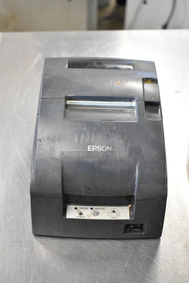 Epson receipt printer, used condition, black finish, control panel with power and feed buttons. Part of 6-item auction set.
