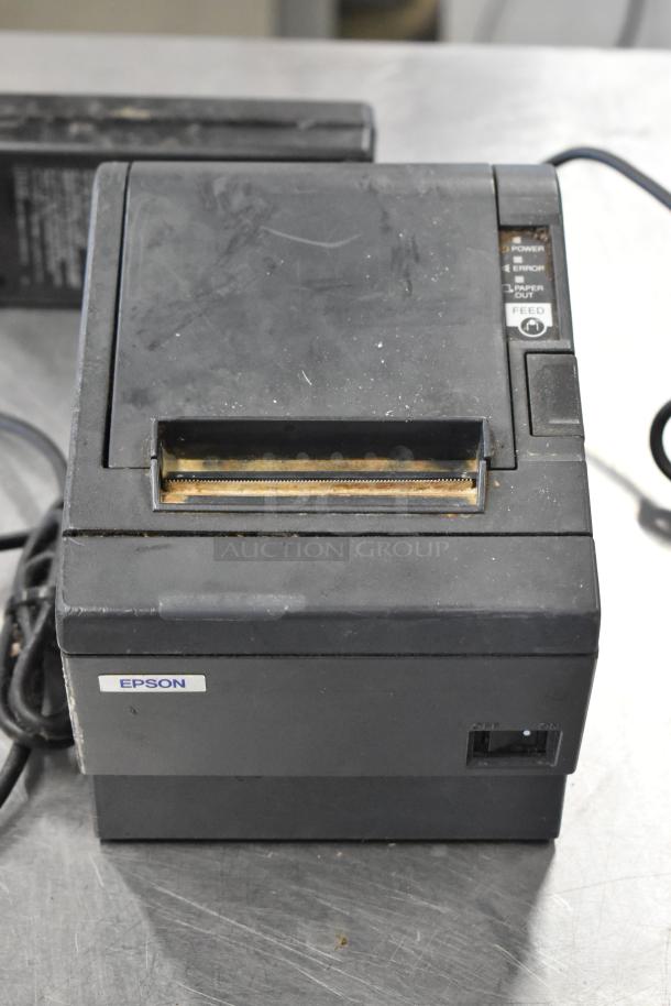 Epson receipt printer with visible wear, includes power and paper indicators, labeled "Epson." Part of a lot of six.