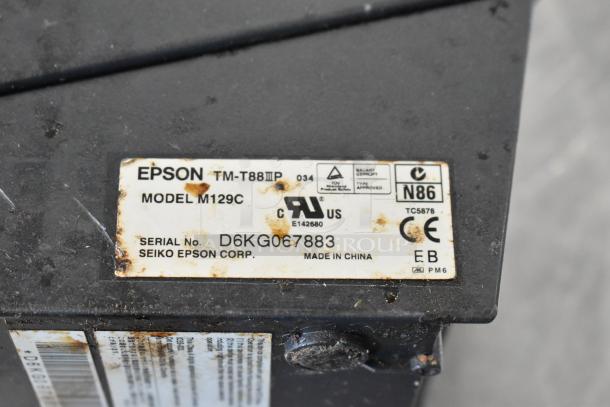 Epson TM-T88III receipt printer, model M129C, with visible wear. Serial No. D6KG067883, made in China by Seiko Epson Corp.