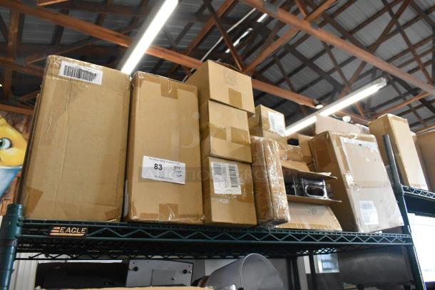Auction lot of various brand new items, including egg dispenser, stackable storage drawer, and food chopper cup. Boxes are sealed with visible labels showing item numbers and site information.