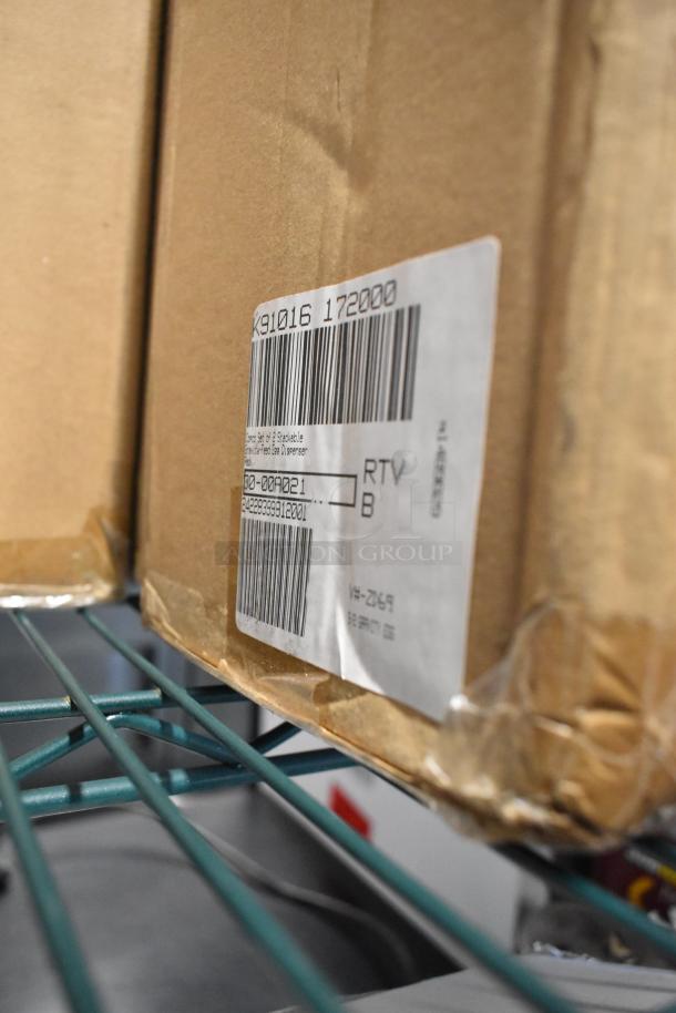 Brown cardboard box with a shipping label, containing brand new items like an egg dispenser, stackable drawer, food chopper.