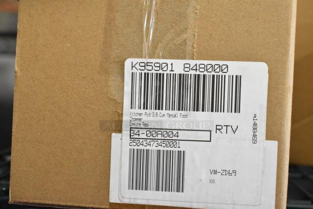 Brown shipping box with label reading "KitchenAid 3.8 Cup Manual Food Chopper, Empire Red." Auction lot includes egg dispenser, storage drawer.