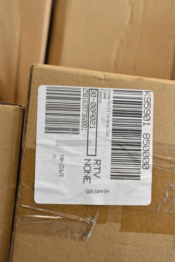 Cardboard box with a label displaying barcodes and text for item tracking. Likely contains new kitchen items like an egg dispenser and food chopper.