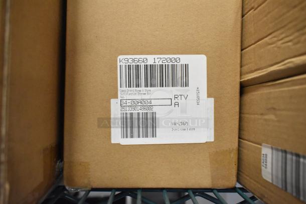Auction item image showing a brown cardboard box with a label marked "Copco 3-in-1 Rinse & Store Multi-function Storage Bin, Red."