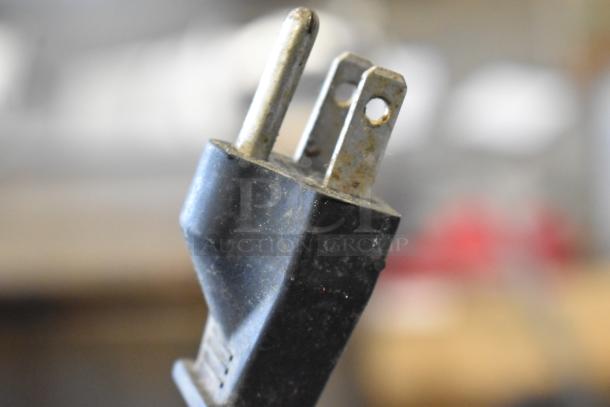 Close-up of a black electrical plug for a kitchen appliance set; condition slightly worn, compatible with 115 volts, 1 phase.