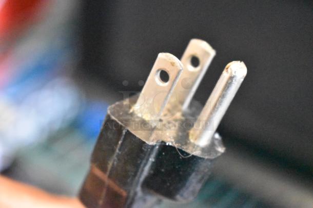 Close-up of a three-pronged power plug for the Sharp R-3A55 Countertop Microwave Oven, showing metal prongs in used condition.