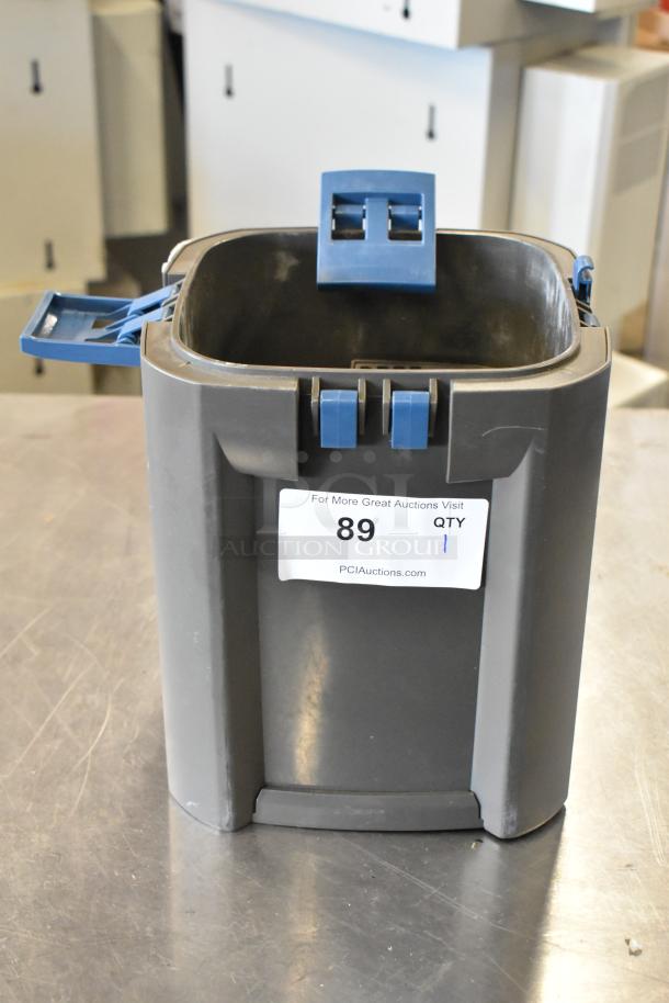 Oase Gray Bin with blue clasps, good condition, auction tag #89 from PCI Auctions.