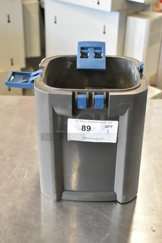 Oase Gray Bin with blue clasps, good condition, auction tag #89 from PCI Auctions.