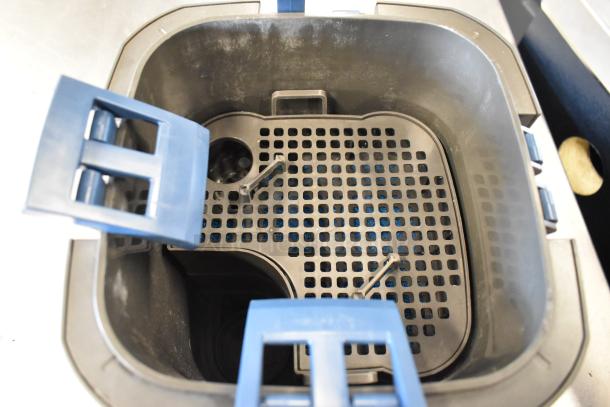 Oase Gray Bin with blue latch, featuring a grid insert. Appears in good condition, designed for filtration purposes.