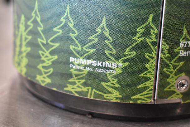 Air pot with green tree pattern design, labeled "PUMPSKINS® Patent No. 5322578." Features stainless steel trim.