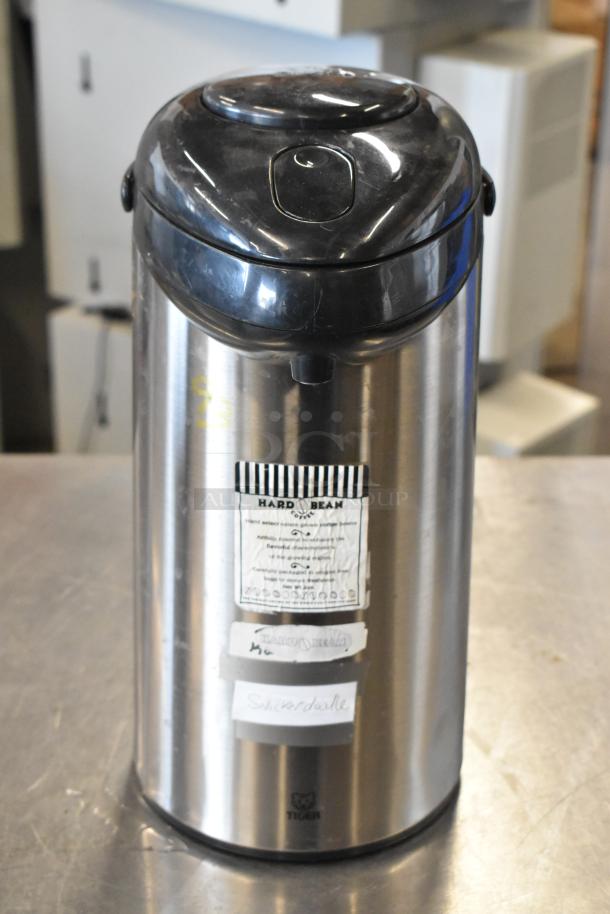 Stainless steel Tiger air pot, with black lid and pump, labeled "Hard Bean" and "Snickerdoodle." Gently used condition.