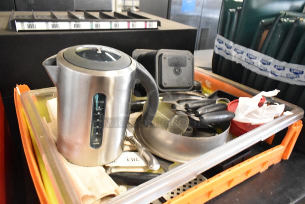 Lot of kitchen items including a stainless steel kettle, various knives, and pans. Items in used condition, labels unclear.