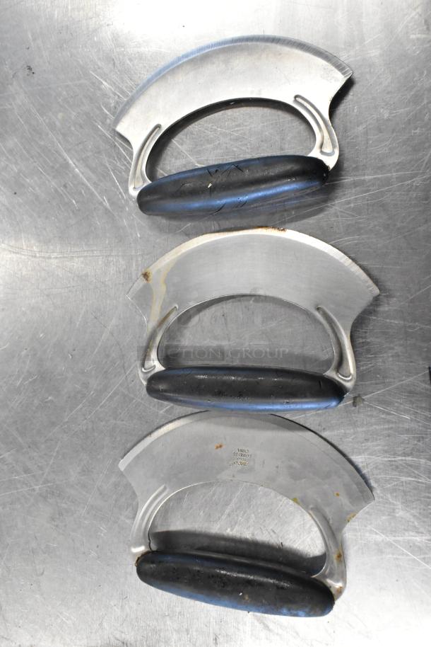 Lot of three rocking cutters with black handles, stainless steel blades marked "Zimco, Stainless, China." Visible wear.