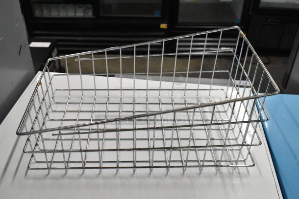 Metal wire basket with sturdy grid design, part of a lot including stainless steel bin, offers multi-use storage.
