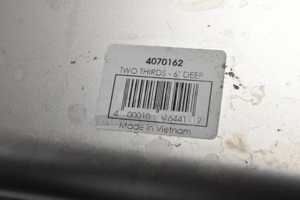 Barcode label on metal surface reads "4070162, Two Thirds - 6" Deep, Made in Vietnam." Potential auction item detail.
