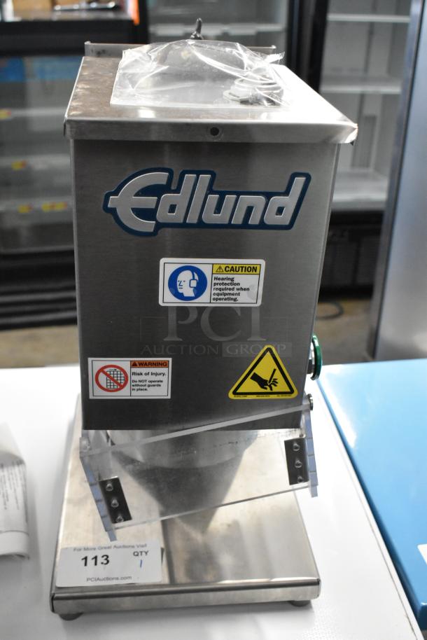 BRAND NEW Edlund 610 Air Powered Crown Punch Can Opener, stainless steel, caution labels visible, scratch and dent condition.