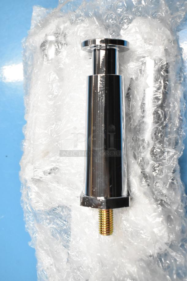 Stainless steel component wrapped in bubble wrap, reflecting light. Appears unused, part of a larger product.