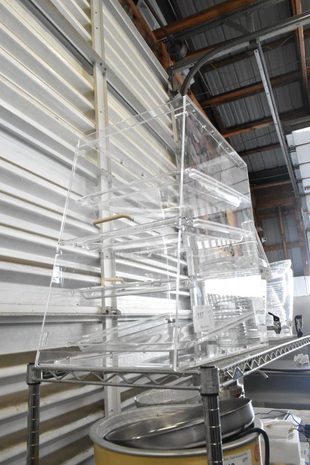 Brand new clear poly dry display case merchandiser with minor scratches, featuring multiple shelves for product visibility.