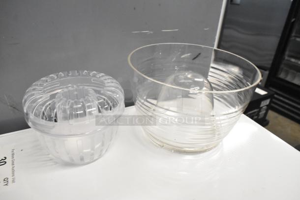 2 clear poly beverage dispensers, brand new, with scratch and dent condition. Visible cracks shown in image.