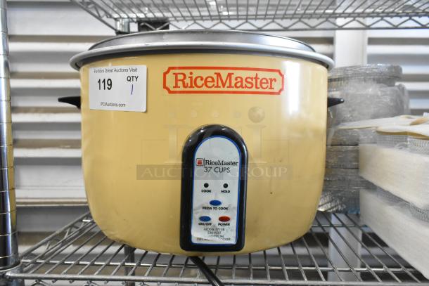 BRAND NEW RiceMaster Town 57138 electric rice cooker, 74 cup capacity, 230 volts, some scratches and dents visible.